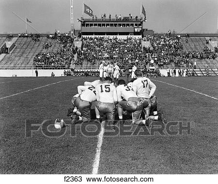 1940S 1950S School Football Players In Kneeling Huddle On Field View Large Photo Image Stock Image - 1940S 1950S School Football Players In Kneeling Huddle On Field . Fotosearch
