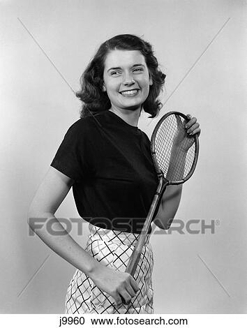 1940S 1950S Smiling Brunette Woman Girl Holding Badminton Racket View Large Photo Image Stock Image - 1940S 1950S Smiling Brunette Woman Girl Holding Badminton Racket . Fotosearch