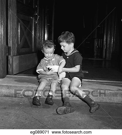 1940S 1950S Two Boys Sitting On Front Steps Holding A Kitten View Large Photo Image Stock Image - 1940S 1950S Two Boys Sitting On Front Steps Holding A Kitten. Fotosearch