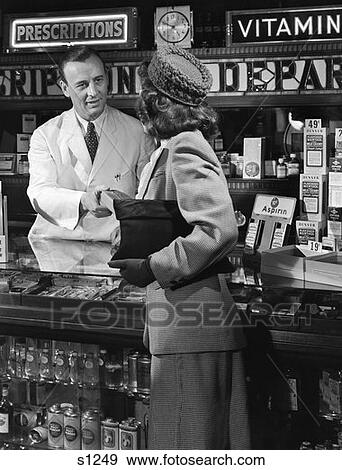 1940S 1950S Woman From Behind Accepting Box From Man Pharmacist At Drug Counter Pharmacy View Large Photo Image Stock Photo - 1940S 1950S Woman From Behind Accepting Box From Man Pharmacist At Drug Counter Pharmacy . Fotosearch