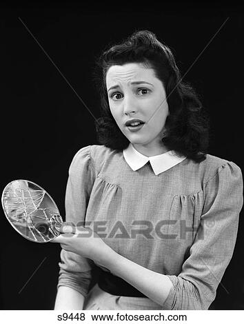 Stock Photo - 1940S 1950S Woman Holding Broken Mirror Shattered Worried Expression Seven Years Bad Luck Supersition Unlucky Fortune Fate. Fotosearch