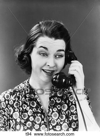 1940S 1950S Woman In Sunflower Print Dress Talking Into Telephone Smiling Listening Facial Expression View Large Photo Image Picture - 1940S 1950S Woman In Sunflower Print Dress Talking Into Telephone Smiling Listening Facial Expression . Fotosearch