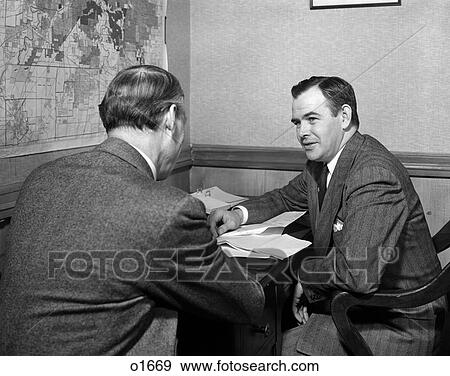 1940S 2 Men At Desk One Faces Camera Other From Back Meeting Conference Interview Map On Wall View Large Photo Image Stock Photo - 1940S 2 Men At Desk One Faces Camera Other From Back Meeting Conference Interview Map On Wall . Fotosearch