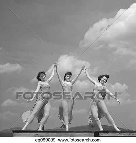 1940S 3 Women Modern Dancers Dancing Outdoors Against Sky With Clouds View Large Photo Image Stock Photo - 1940S 3 Women Modern Dancers Dancing Outdoors Against Sky With Clouds. Fotosearch