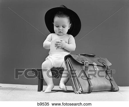 1940S Baby In Fedora Seated On Stool Writing In Notebook With Briefcase At Side View Large Photo Image Stock Photography - 1940S Baby In Fedora Seated On Stool Writing In Notebook With Briefcase At Side . Fotosearch