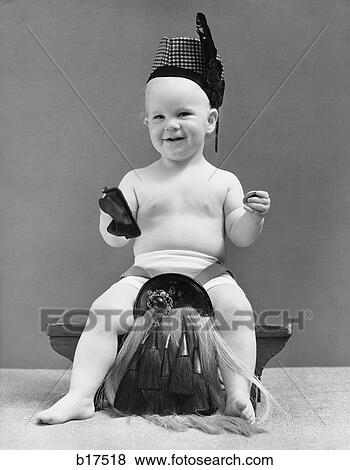 Stock Photo - 1940S Baby In Scottish Garb Sitting On Stool Taking Coin Out Of Change Purse . Fotosearch