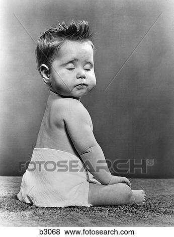 1940s Baby Seated With Back To Camera Turning Head To Viewer With