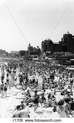 1940S Beach Crowd Of Sunbathers On The Sand In Swimsuits With The Boardwalk In The Background Atlantic City New Jersey View Large Photo Image Stock Photo - 1940S Beach Crowd Of Sunbathers On The Sand In Swimsuits With The Boardwalk In The Background Atlantic City New Jersey. Fotosearch