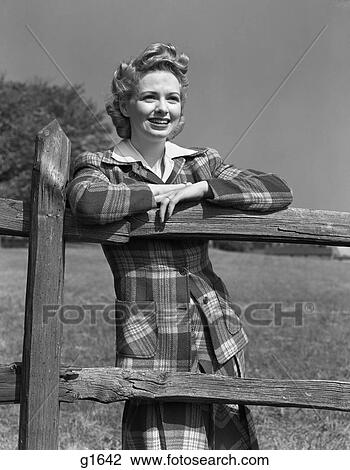 1940S Blonde Woman Smiling Portrait Leaning Arms On Wooden Fence Wearing Plaid Tartan Suit Fashion View Large Photo Image Stock Image - 1940S Blonde Woman Smiling Portrait Leaning Arms On Wooden Fence Wearing Plaid Tartan Suit Fashion . Fotosearch
