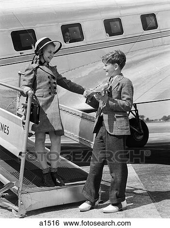 1940S Boy Girl Walking Off Boarding Ramp Of Airplane Boy Holds Toy Plane Formal Dress Fashion Suit Tie View Large Photo Image Stock Photograph - 1940S Boy Girl Walking Off Boarding Ramp Of Airplane Boy Holds Toy Plane Formal Dress Fashion Suit Tie . Fotosearch