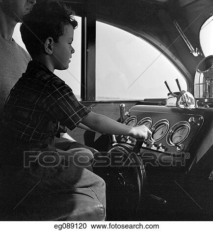 1940S Boy Sitting At Controls Of Motor Yacht With Father View Large Photo Image Stock Image - 1940S Boy Sitting At Controls Of Motor Yacht With Father. Fotosearch