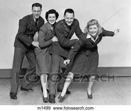 Stock Photo - 1940S Chorusline Of 2 Male Soldiers And 2 Women Smiling At Camera Dancing. Fotosearch