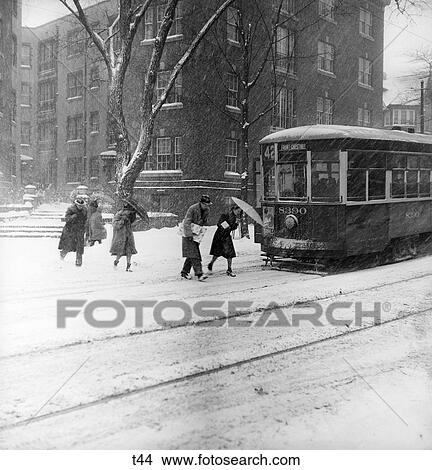 1940S City Winter Scene Pedestrians Crossing Street Snow Trolley Car Transportation View Large Photo Image Picture - 1940S City Winter Scene Pedestrians Crossing Street Snow Trolley Car Transportation . Fotosearch