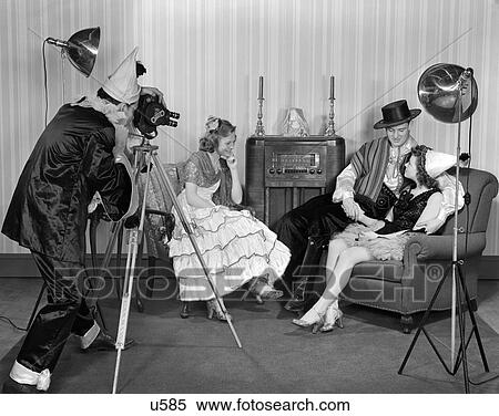 1940S Costumed Teen Group Of 2 Men And 2 Women In A Living Room With Armchairs And Floor Model Radio View Large Photo Image Stock Photography - 1940S Costumed Teen Group Of 2 Men And 2 Women In A Living Room With Armchairs And Floor Model Radio . Fotosearch