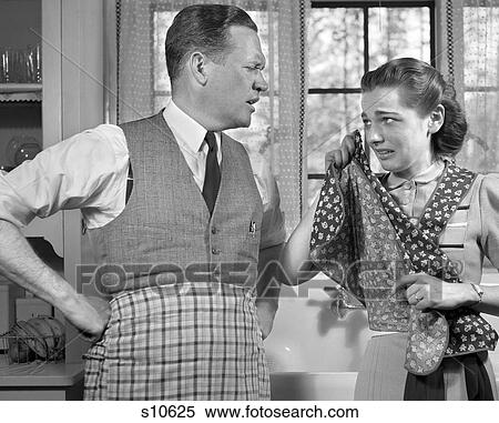 1940S Couple In Kitchen Wearing Aprons With Woman Crying & Wiping Eyes With Apron View Large Photo Image Stock Photography - 1940S Couple In Kitchen Wearing Aprons With Woman Crying & Wiping Eyes With Apron . Fotosearch