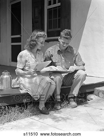 1940S Couple Man Woman Sitting On Porch Farm House Reviewing Ledger Papers Milk Metal Container By Woman View Large Photo Image Stock Image - 1940S Couple Man Woman Sitting On Porch Farm House Reviewing Ledger Papers Milk Metal Container By Woman. Fotosearch
