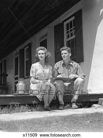 1940S Couple Man Woman Sitting Porch Farm House Looking Off To Side Ledger Book Man'S Lap Small Milk Container Woman Plaid Dress View Large Photo Image Stock Photo - 1940S Couple Man Woman Sitting Porch Farm House Looking Off To Side Ledger Book Man'S Lap Small Milk Container Woman Plaid Dress. Fotosearch