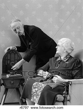 1940S Elderly Couple Listening To Radio While She Knits View Large Photo Image Stock Photo - 1940S Elderly Couple Listening To Radio While She Knits . Fotosearch