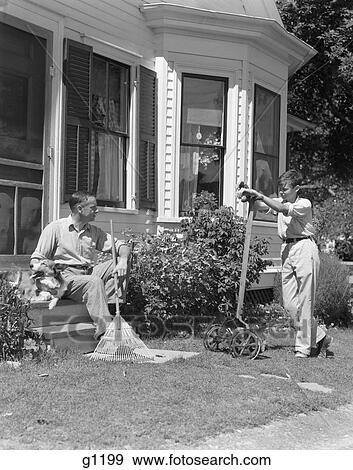 1940S Father Sits On Porch Steps Holding Rake Talking To Son Standing Holding Lawnmower Backyard Window Doorway View Large Photo Image Stock Photo - 1940S Father Sits On Porch Steps Holding Rake Talking To Son Standing Holding Lawnmower Backyard Window Doorway . Fotosearch