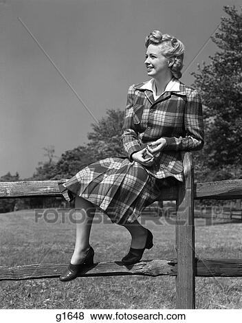 1940S Full Length Portrait Of Blonde Woman Sitting On A Wooden Fence Wearing Plaid Tartan Suit View Large Photo Image Stock Photo - 1940S Full Length Portrait Of Blonde Woman Sitting On A Wooden Fence Wearing Plaid Tartan Suit . Fotosearch