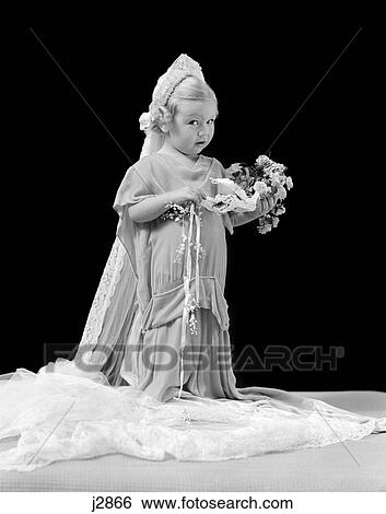 1940S Girl In Oversized Wedding Gown & Veil Holding Bouquet With Confused Expression View Large Photo Image Stock Photograph - 1940S Girl In Oversized Wedding Gown & Veil Holding Bouquet With Confused Expression . Fotosearch