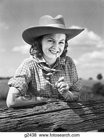 1940S Girl In Ten Gallon Western Cowboy Hat & Plaid Shirt Smiling While Holding A Blade Of Grass Between Her Teeth View Large Photo Image Stock Photo - 1940S Girl In Ten Gallon Western Cowboy Hat & Plaid Shirt Smiling While Holding A Blade Of Grass Between Her Teeth . Fotosearch