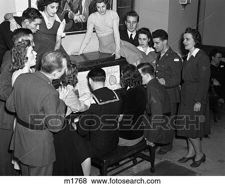 1940S Group Of Soldiers Sailors And Women In A Volunteer Uso Canteen Around Piano Singing View Large Photo Image Stock Photo - 1940S Group Of Soldiers Sailors And Women In A Volunteer Uso Canteen Around Piano Singing . Fotosearch