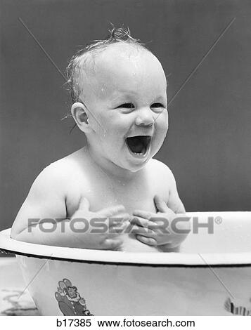 1940S Happy Laughing Smilng Baby Sitting In Wash Basin Wet Hair Hands On Chest Taking A Bath Clean Fun Water View Large Photo Image Stock Photography - 1940S Happy Laughing Smilng Baby Sitting In Wash Basin Wet Hair Hands On Chest Taking A Bath Clean Fun Water . Fotosearch