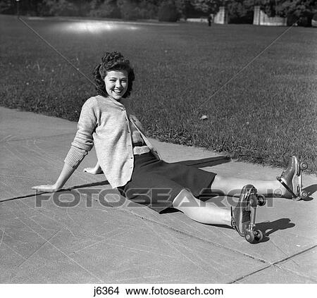 1940S Laughing Young Woman Teen Girl Sitting On Sidewalk Having Fallen Down On Roller Skates View Large Photo Image Picture - 1940S Laughing Young Woman Teen Girl Sitting On Sidewalk Having Fallen Down On Roller Skates . Fotosearch