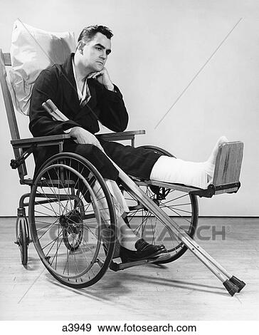 1940S Man In Wheelchair With Cast On Left Leg Holding Crutches View Large Photo Image Stock Photo - 1940S Man In Wheelchair With Cast On Left Leg Holding Crutches . Fotosearch