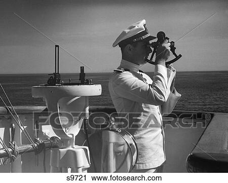 Stock Image - 1940S Man Sailor Captain Officer Using Sextant On Bridge Of Ship Navigation Latitude Longitude Calculation Navy. Fotosearch