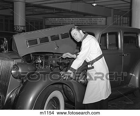 Picture - 1940S Mechanic Looking At Camera Working Under Hood Of Car Wearing Work Smock Uniform Garage . Fotosearch