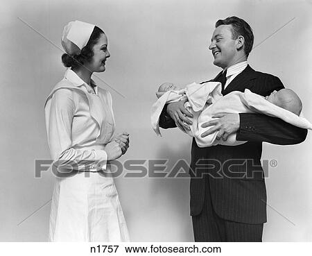 1940S Nurse With New Father Holding Twin Babies View Large Photo Image Stock Photo - 1940S Nurse With New Father Holding Twin Babies . Fotosearch