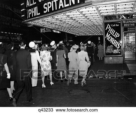1940S Nyc Broadway At Night Marquee Of Movie Theater With Soldiers Sailors And Women On The Sidewalk Of West 51St Street View Large Photo Image Stock Image - 1940S Nyc Broadway At Night Marquee Of Movie Theater With Soldiers Sailors And Women On The Sidewalk Of West 51St Street. Fotosearch