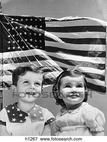 1940S Patriotic Composite Of Smiling Boy And Girl Over Background Of The American Flag Blowing In The Wind View Large Photo Image Stock Photo - 1940S Patriotic Composite Of Smiling Boy And Girl Over Background Of The American Flag Blowing In The Wind. Fotosearch