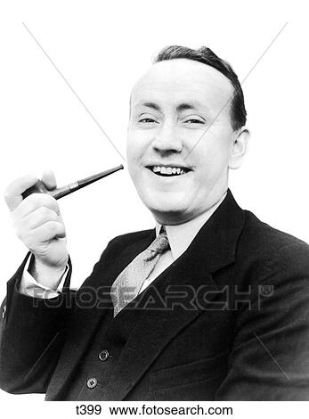 1940S Portrait Man Holding Pipe In His Hand Smiling At Camera Dressed In Suit And Tie Smoking Bad Habit Tobacco View Large Photo Image Stock Photo - 1940S Portrait Man Holding Pipe In His Hand Smiling At Camera Dressed In Suit And Tie Smoking Bad Habit Tobacco . Fotosearch