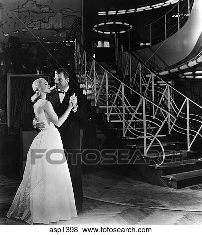 Stock Photo - 1940S Romantic Couple Dancing Before ArtDeco Staircase. Fotosearch