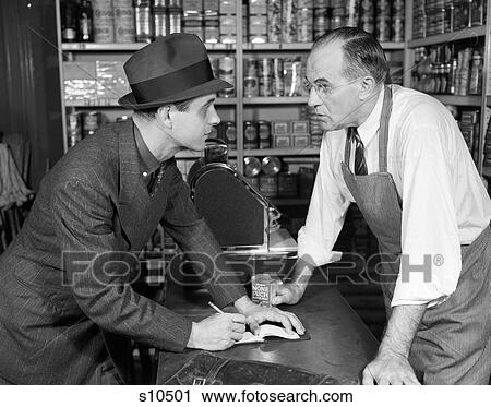 1940S Salesman Taking An Order From A Grocer With Pad & Pencil On The Counter Top He'S Dressed In Suit View Large Photo Image Stock Image - 1940S Salesman Taking An Order From A Grocer With Pad & Pencil On The Counter Top He'S Dressed In Suit . Fotosearch