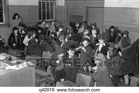 1940S School Children Putting On Their Coats To Leave Classroom For Recess Boys Girls Students Education Retro View Large Photo Image Stock Photo - 1940S School Children Putting On Their Coats To Leave Classroom For Recess Boys Girls Students Education Retro. Fotosearch