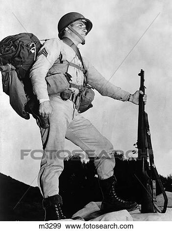 1940S Sergeant In Army Uniform In Profile Posing With Rifle Helmet Backpack And Boots View Large Photo Image Stock Photo - 1940S Sergeant In Army Uniform In Profile Posing With Rifle Helmet Backpack And Boots. Fotosearch