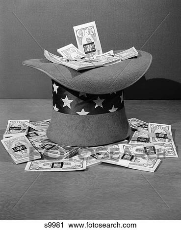 1940S Set-Up Of Upside Down Uncle Sam Hat Filled With Bundles Of $100 Bills Overflowing Around It View Large Photo Image Stock Image - 1940S Set-Up Of Upside Down Uncle Sam Hat Filled With Bundles Of $100 Bills Overflowing Around It . Fotosearch