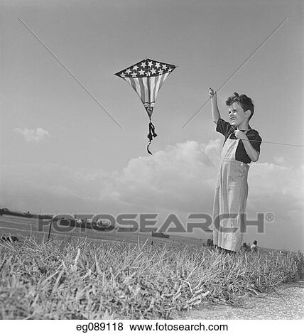1940S Smiling Boy Flying Stars And Stripes Kite View Large Photo Image Stock Photo - 1940S Smiling Boy Flying Stars And Stripes Kite. Fotosearch