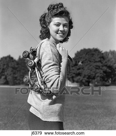 1940S Smiling Brunette Teen Girl Carrying Metal Roller Skates Over Her Shoulder View Large Photo Image Stock Photo - 1940S Smiling Brunette Teen Girl Carrying Metal Roller Skates Over Her Shoulder . Fotosearch
