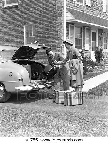 1940S Smiling Couple Woman Handing Man Luggage To Put In Trunk Of Sedan Car In Driveway By Home View Large Photo Image Stock Photography - 1940S Smiling Couple Woman Handing Man Luggage To Put In Trunk Of Sedan Car In Driveway By Home. Fotosearch