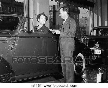 1940S Smiling Man Hat Sitting Convertible Coupe Top Down Talking Salesman Pin Stripe Suit Automobile Showroom View Large Photo Image Stock Image - 1940S Smiling Man Hat Sitting Convertible Coupe Top Down Talking Salesman Pin Stripe Suit Automobile Showroom. Fotosearch