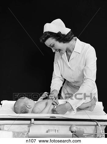 1940S Smiling Nurse Changing Baby Diaper Nursery View Large Photo Image Stock Photo - 1940S Smiling Nurse Changing Baby Diaper Nursery . Fotosearch