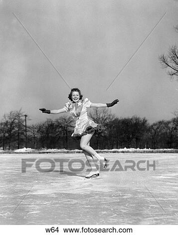 1940S Smiling Woman On Ice Outdoors Ice Skating Arms Out About To Do Backward Jump View Large Photo Image Picture - 1940S Smiling Woman On Ice Outdoors Ice Skating Arms Out About To Do Backward Jump . Fotosearch