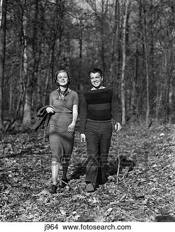 1940S Teen Couple Boy Girl Walking In Autumn Woods Landscape View Large Photo Image Picture - 1940S Teen Couple Boy Girl Walking In Autumn Woods Landscape . Fotosearch