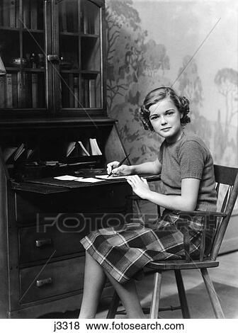 1940S Teen Girl Sitting At Desk Writing A Letter View Large Photo Image Stock Photo - 1940S Teen Girl Sitting At Desk Writing A Letter. Fotosearch