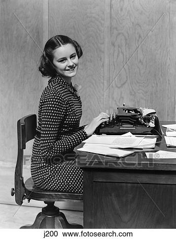 1940S Teen Girl Smiling Sitting At Desk Using Manual Typewriter Office Secretary View Large Photo Image Stock Image - 1940S Teen Girl Smiling Sitting At Desk Using Manual Typewriter Office Secretary . Fotosearch